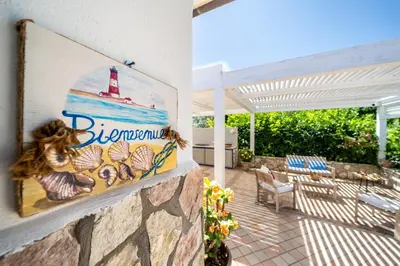 a painting of a lighthouse on the wall of a house at VILLA HIBISCUS in Castellammare del Golfo
