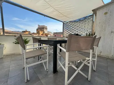 a table and chairs on a balcony with a view at Meetup on The Terrace View With private parking in Palermo
