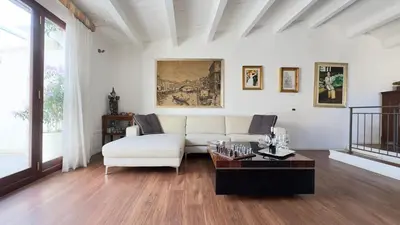 a living room with a white couch and a table at Meetup on The Terrace View With private parking in Palermo