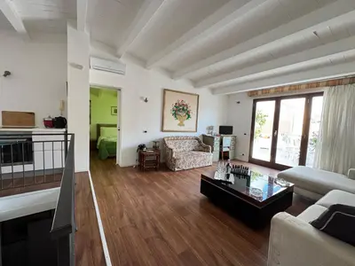 a living room with a couch and a coffee table at Meetup on The Terrace View With private parking in Palermo