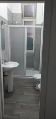 a bathroom with a toilet and a sink at Manzoni rooms in Palermo