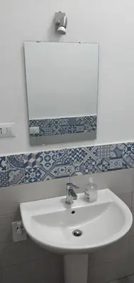 a bathroom with a white sink and a mirror at Manzoni rooms in Palermo