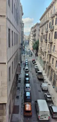 a view of a city street with cars parked at Manzoni rooms in Palermo