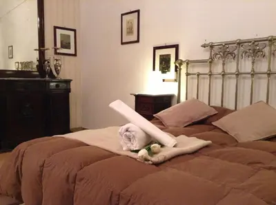 a stuffed animal is laying on a bed at Verdi Apartment in Castellammare del Golfo