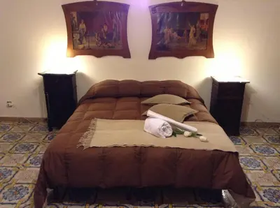a bed with two pillows and towels on it at Verdi Apartment in Castellammare del Golfo