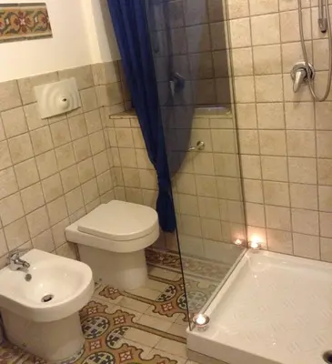 a bathroom with a toilet and a shower at Verdi Apartment in Castellammare del Golfo