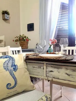 a dining room table with a seahorse pillow at Case Vanella Grande aspra bagheria in Bagheria