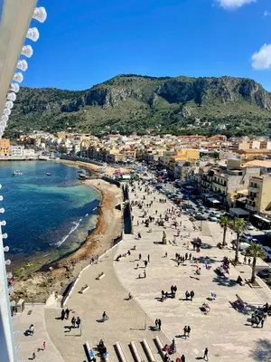 a beach with a crowd of people and the ocean at Case Vanella Grande aspra bagheria in Bagheria