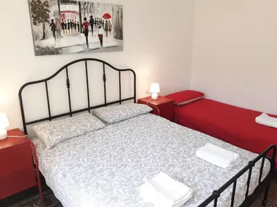 a bedroom with a bed and two night stands at Olivuzza Apartment in Palermo