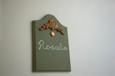 a sign on a wall with a cookie on it at Dimora Sinibaldi in Palermo
