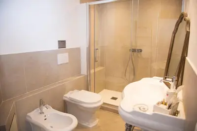 a bathroom with a shower and a toilet and a sink at Dimora Sinibaldi in Palermo