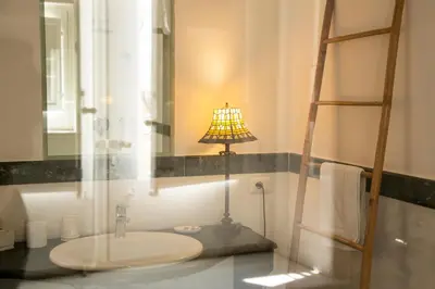 a bathroom with a sink and a lamp on a counter at Dimora Sinibaldi in Palermo