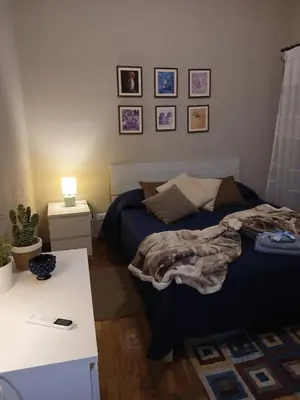 a bedroom with a bed and a white table at Casa da Michelino in Palermo