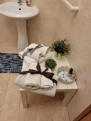 a pile of towels on a table in a bathroom at Casa da Michelino in Palermo