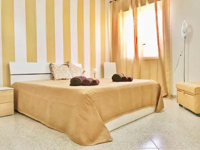 a bedroom with a large bed with towels on it at Francesco&Maria in Villaggio Tedeschi