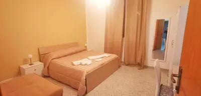 a small bedroom with a bed and a mirror at Francesco&Maria in Villaggio Tedeschi