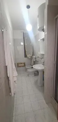 a white bathroom with two toilets and a sink at Francesco&Maria in Villaggio Tedeschi