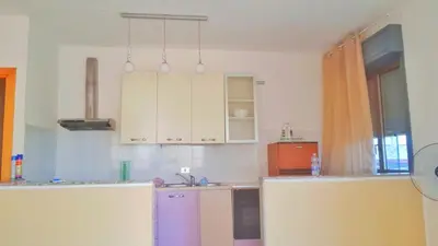 a kitchen with white cabinets and a sink at Francesco&Maria in Villaggio Tedeschi
