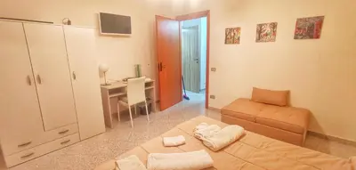 a room with a bed and a desk and a table at Francesco&Maria in Villaggio Tedeschi