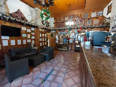 a restaurant with a bar with a bike on the wall at Hotel La Rocca in Roccapalumba
