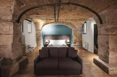 a bedroom with a shower and a bed and a bathroom at PALAZZO SANTAMARINA Luxury Suite & Spa in Palermo