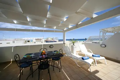 a patio with a table and chairs on a balcony at Venere ed Enea - Appartamenti Vista Mare in San Vito lo Capo