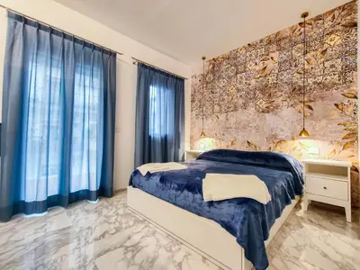 a bedroom with a bed and a large window at Cubacalatafimi Rooms in Palermo