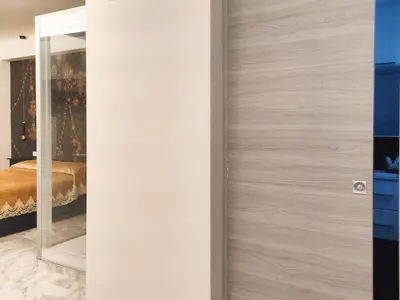 a wooden door in a bedroom with a mirror at Cubacalatafimi Rooms in Palermo