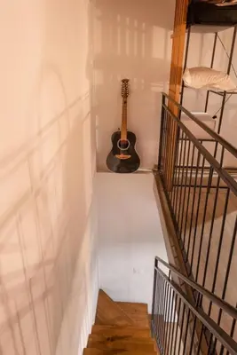 a staircase with a guitar in a room at CityCenter Unique Apartment-Sleeps 2- Pet Friendly in Palermo