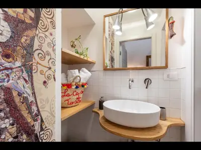 a bathroom with a white sink and a mirror at CityCenter Unique Apartment-Sleeps 2- Pet Friendly in Palermo