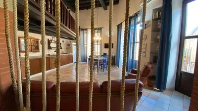 a room with a bed with a table in it at Casa Zagato Le Fuoriserie in Palermo