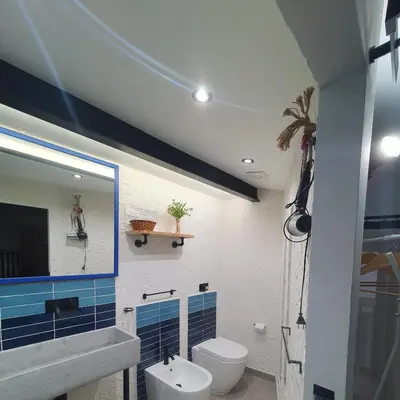a bathroom with a toilet and a sink and a mirror at Casa Zagato Le Fuoriserie in Palermo