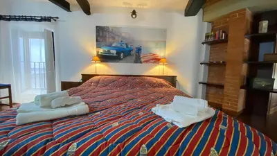 a bedroom with a bed with two towels on it at Casa Zagato Le Fuoriserie in Palermo