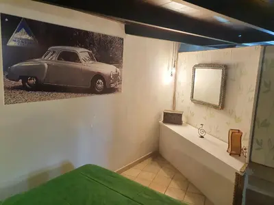 a room with a painting of a car on the wall at Casa Monviso Le fuoriserie in Palermo
