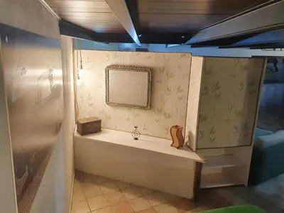 a bathroom with a tub and a mirror on the wall at Casa Monviso Le fuoriserie in Palermo