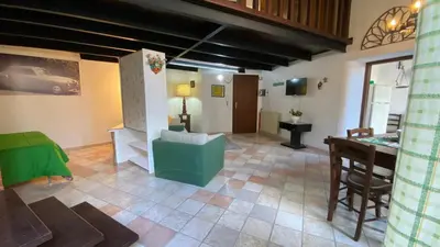 a living room with a couch and a table at Casa Monviso Le fuoriserie in Palermo