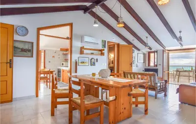 a dining room with a table and chairs at Mansarda Belvedere in Alcamo Marina