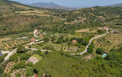 an aerial view of a village in a valley with trees at Nocellara in Alia
