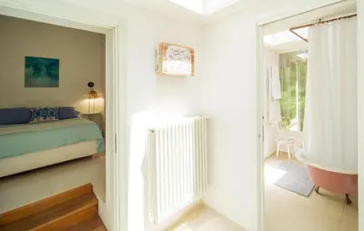 a bedroom with a bed and a tub and a window at Nocellara in Alia