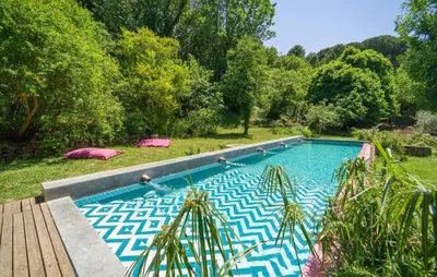 a swimming pool in the middle of a garden at Nocellara in Alia