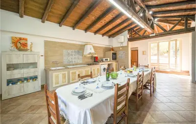 a dining room with a table and chairs in a kitchen at Villa Spera in Mandra Capreria