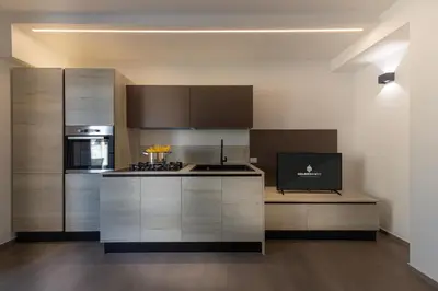 a kitchen with stainless steel cabinets and a stove at Gelso Bianco Boutique Apartments in Campofelice di Roccella