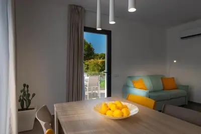 a bowl of oranges on a table in a living room at Gelso Bianco Boutique Apartments in Campofelice di Roccella