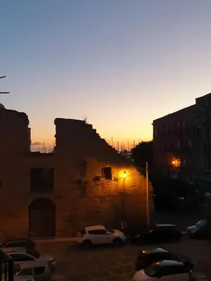 a sunset with cars parked in a parking lot at Residenza Tarzanà in Palermo