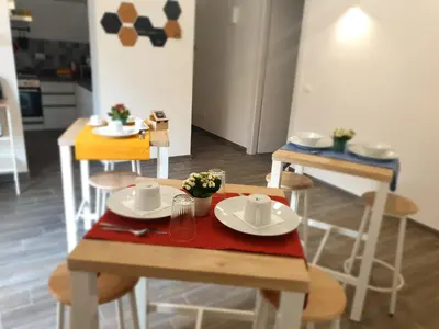 a table and chairs with plates and cups on it at Residenza Tarzanà in Palermo