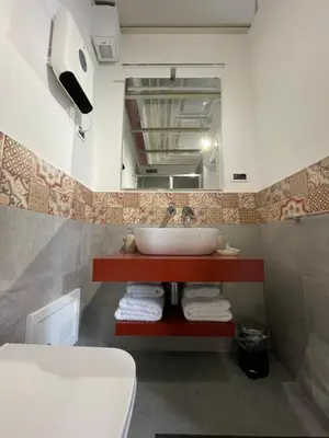 a bathroom with a sink and a mirror at Arricría Room Suite in Palermo