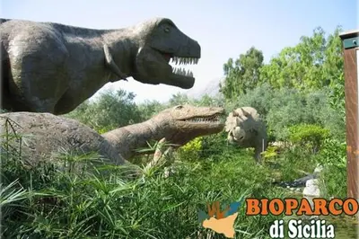 a group of dinosaur statues of dinosaurs in the grass at Casa vacanze Ines in Carini