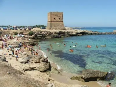 a group of people in the water at a beach at Casa vacanze Ines in Carini