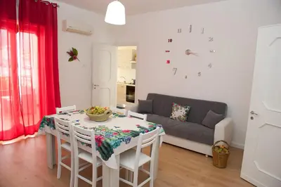 a living room with a table and a couch at Casa vacanze Ines in Carini