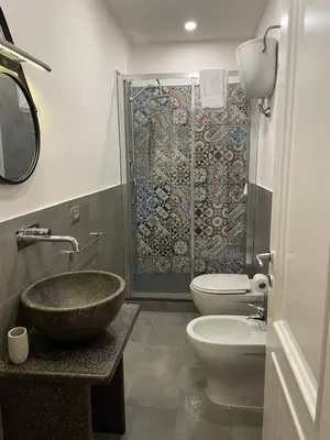 a bathroom with a sink and a toilet and a shower at Posto al Capo in Palermo